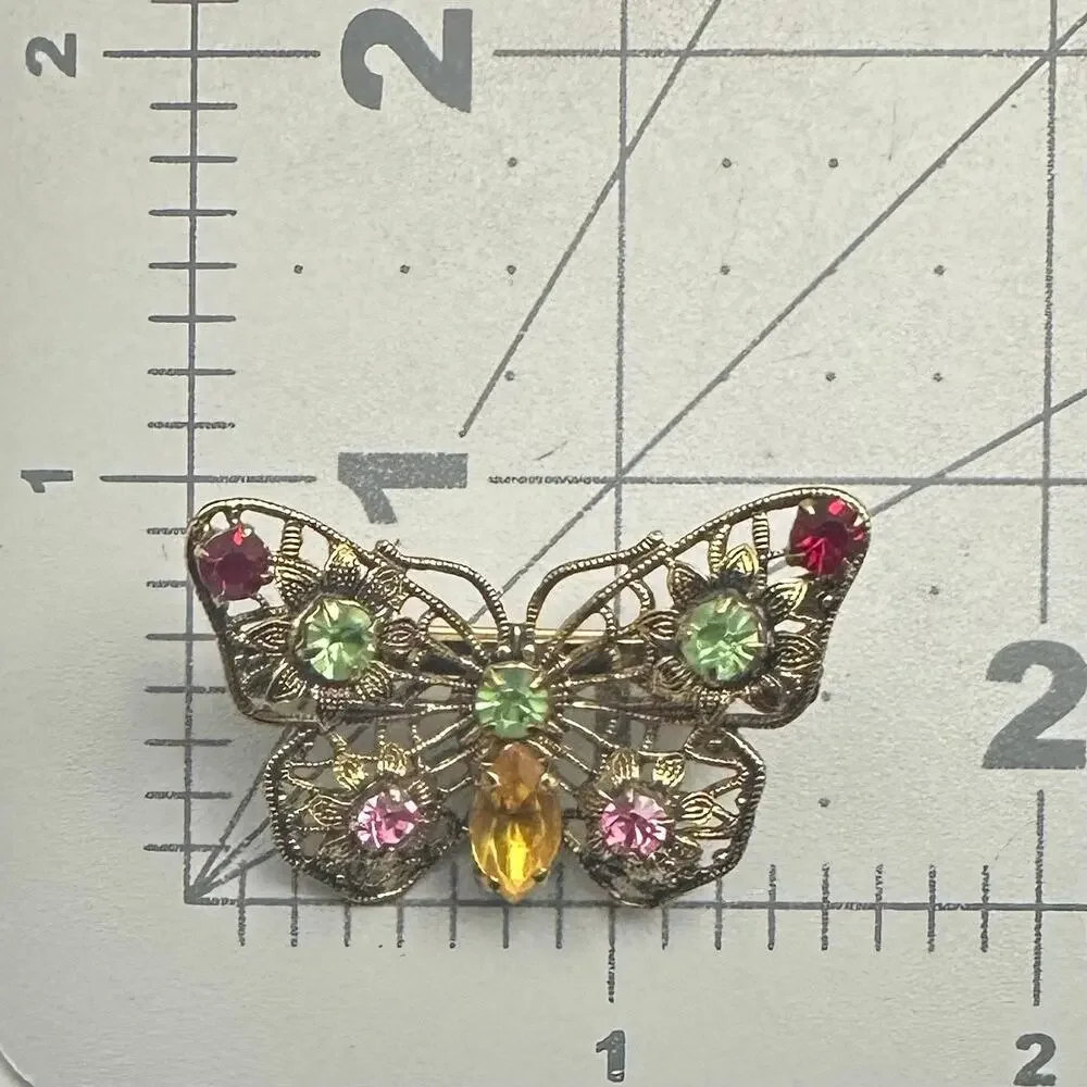 Vintage gold tone filigree multicolor prong set rhinestones butterfly brooch